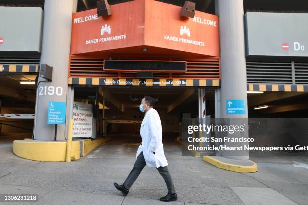 Dr. Kenny Mok, Kaiser Permanente hospitalist walks on O"u2019Farrell Street as he heads to work at the Kaiser Permanente San Francisco Hospital on...
