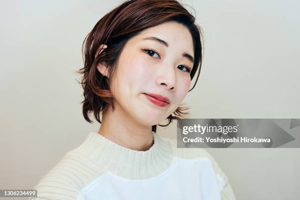 portrait of female beauty salon clerk standing in her store - content japanese ethnicity stock pictures, royalty-free photos & images