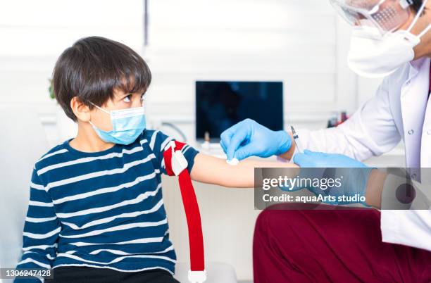 male nurse taking blood sample of child patient ın clinic - anaemia stock pictures, royalty-free photos & images