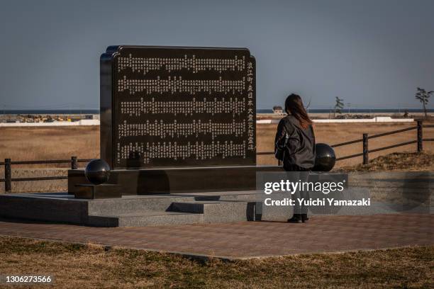 Woman visits a memorial for the victims of the 2011 Tohoku earthquake and tsunami on March 10, 2021 in Namie, Japan. In ceremonies that are expected...