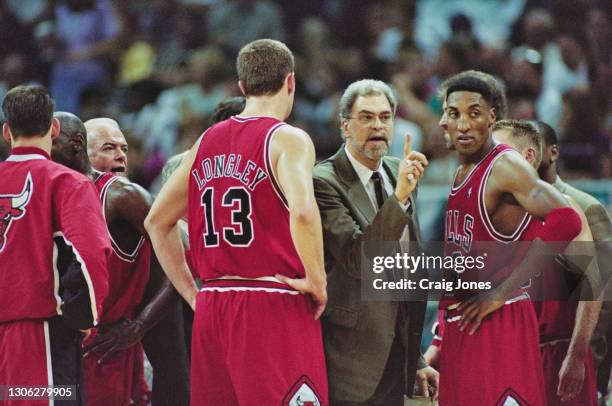 Phil Jackson, Head Coach for the Chicago Bulls talks with his players Scottie Pippen and Luc Longley during Game 4 of the NBA Eastern Conference Semi...