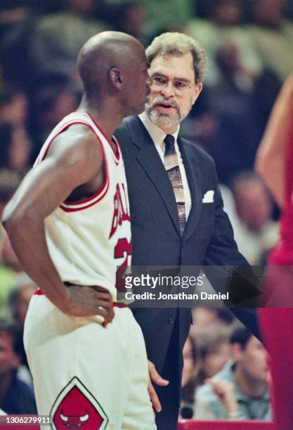 Phil Jackson, Head Coach for the Chicago Bulls talks with Michael Jordan, Shooting Guard for the Bulls during Game 5 of the NBA Eastern Conference...