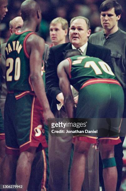 George Karl, Head Coach for the Seattle SuperSonics talks with his Point Guards Gary Payton and Nate McMillan during the NBA Central Division...