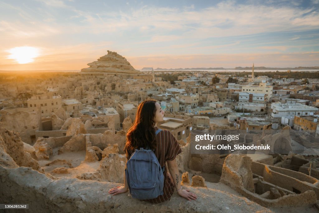 Woman looking at scenic view of Siwa oasis at sunset