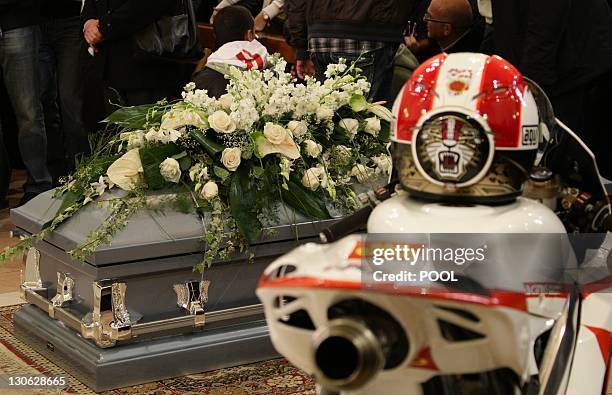 Helmet and a motorcycle sit near the coffin during the funeral service of Italian MotoGP rider Marco Simoncelli on October 27, 2011 in Coriano, in...