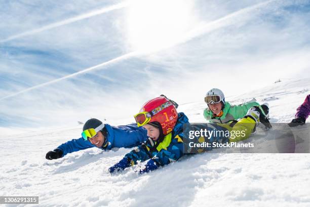 family playing with fresh snow on the mountain - funny snow skiing stock pictures, royalty-free photos & images