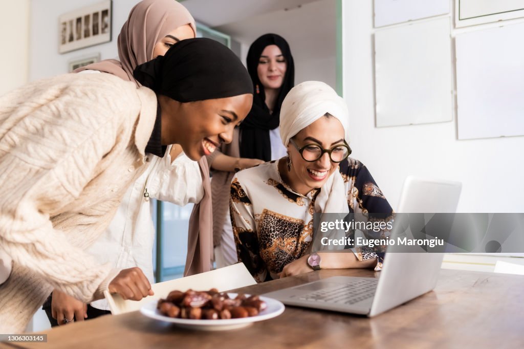 Young muslim women on video call, with plate of dates