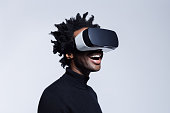 Happy young man using virtual reality glasses