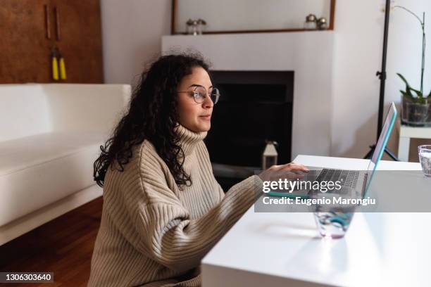 young woman using laptop at home - polo necks stock pictures, royalty-free photos & images