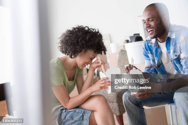 mid adult couple eating chinese take away - chinese takeout stock pictures, royalty-free photos & images