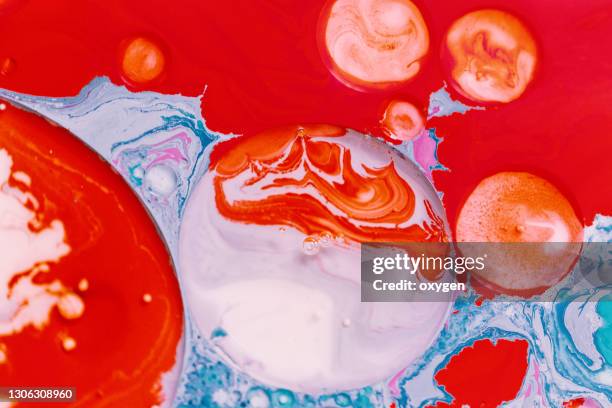 abstract liquid macro oil ink bubbles spot blob red blue background - oil macro stock pictures, royalty-free photos & images