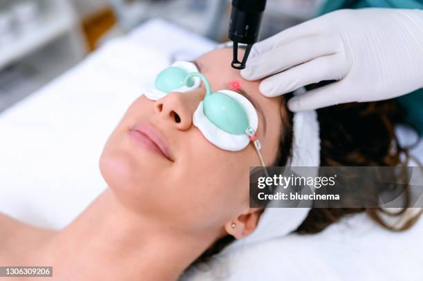 hair removal with laser diod - laser face stock pictures, royalty-free photos & images