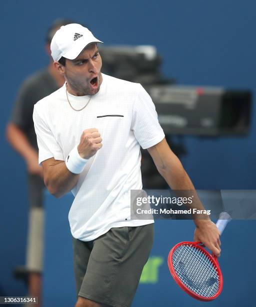 Aslan Karatsev of Russia celebrates winning the first set during his round of 16 match against Dominic Thiem of Austria during Day Three of the Qatar...