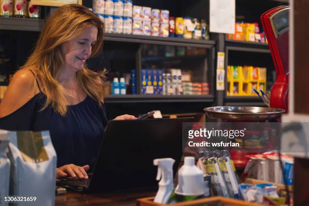 woman in her small grocery store. - mini grocery store stock pictures, royalty-free photos & images