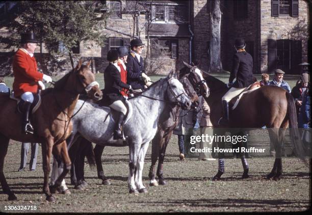 American book editor and former First Lady Jacqueline Onassis and her daughter, Caroline , along with a hunt master and others, sit on their horses...