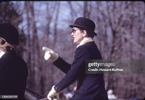 American book editor and former First Lady Jacqueline Onassis sits on her horse before a Thanksgiving Day fox hunt at the Johnson and Johnson estate,...