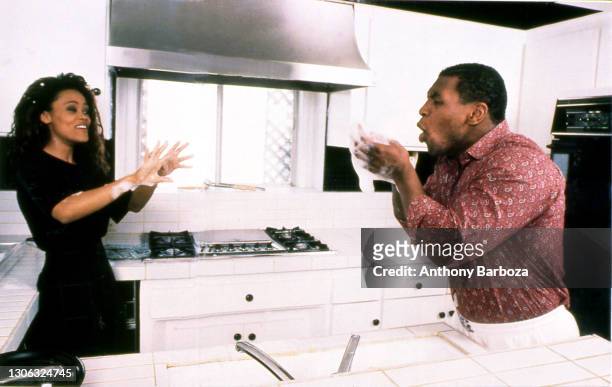 View of married couple American actress Robin Givens and heavyweight boxer Mike Tyson in the kitchen of their home, Los Angeles, California, May...