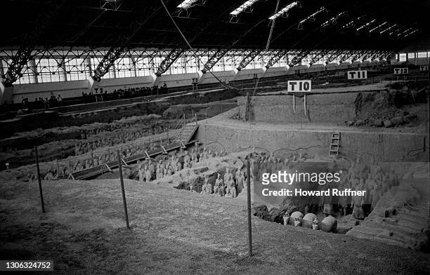 View across the excavated Terracotta Army in the tomb of China's first emperor, Qin Shi Huang Di, Xi'an, Shaanxi, China, April 1986. The warrior and...