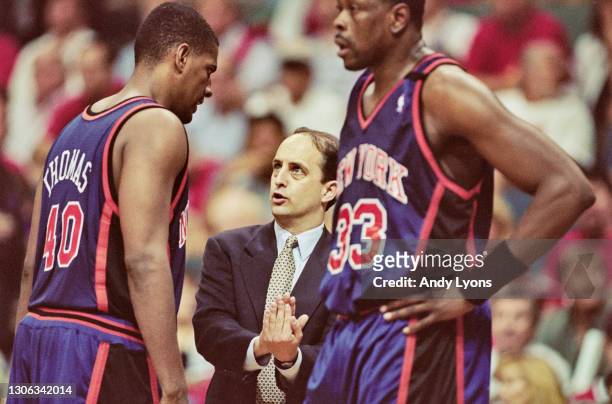 Jeff Van Gundy, Head Coach for the New York Knicks gives play instructions to his Power Forward and Center Kurt Thomas as Patrick Ewing looks on...