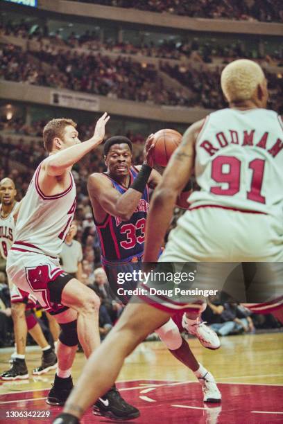 Patrick Ewing, Power Forward and Center for the New York Knicks drives to the basket as Luc Longley of the Chicago Bulls attempts to block during...