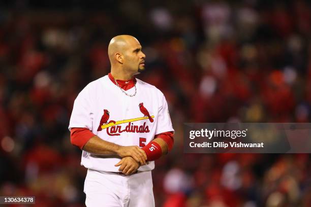 Albert Pujols of the St. Louis Cardinals grabs his wrist as he looks on against the Texas Rangers during Game One of the MLB World Series at Busch...
