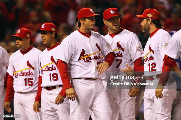 David Freese of the St. Louis Cardinals greets teammates Matt Holliday and Lance Berkman during player introductions against the Texas Rangers during...