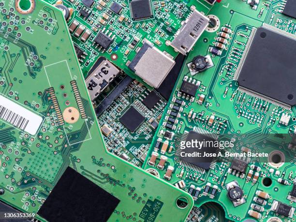 system boards. full frame of high angle view of printed circuit boards to be recycled. - elektronisch afval stockfoto's en -beelden