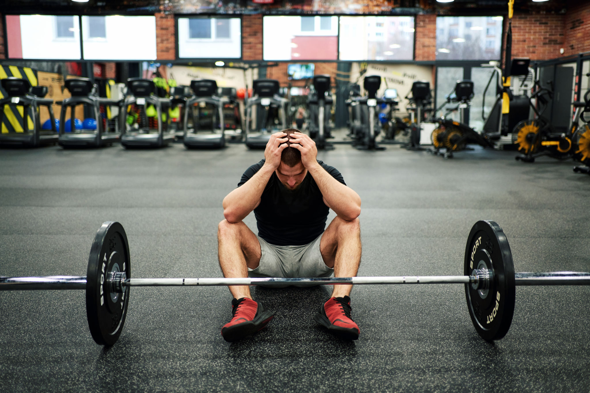 decreased exercise endurance. Male athlete having a headache during work out decreased exercise endurance. Male athlete having a headache during work out