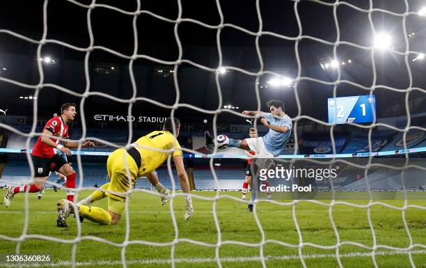 Ilkay Gundogan of Manchester City scores their side's third goal past Alex McCarthy of Southampton during the Premier League match between Manchester...
