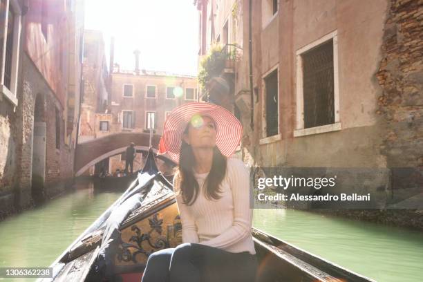 young girl in a gondola tour, venice, veneto, italy, europe - venedig gondel stock-fotos und bilder