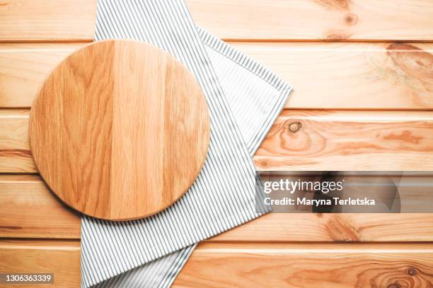 round wooden cutting board with a cloth napkin. - round wooden chopping board stock pictures, royalty-free photos & images