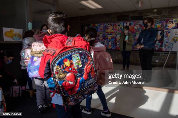 Students arrive for the first day of in-person learning for five days per week at Stark Elementary School on March 10, 2021 in Stamford, Connecticut....