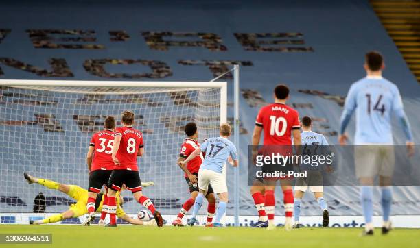 Kevin De Bruyne of Manchester City scores their side's fifth goal past Alex McCarthy of Southampton during the Premier League match between...
