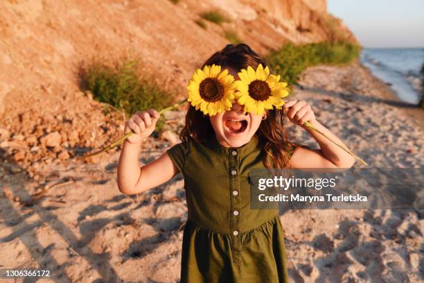 beautiful dark-haired girl in nature. - sunflower faces stock pictures, royalty-free photos & images