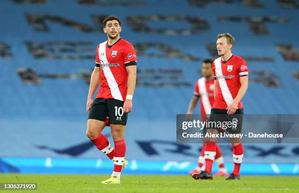 Che Adams of Southampton looks dejected along with team mates after conceding the fifth goal during the Premier League match between Manchester City...