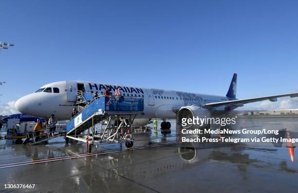 Travelers board the Hawaiian Airlines"u2019 inaugural service to Maui"u2019s Kahului Airport in Long Beach on Wednesday, March 10, 2021.
