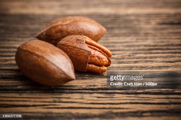 close-up of almonds on table - pacana fotografías e imágenes de stock