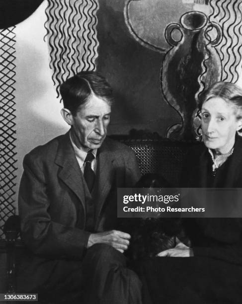 View of married British couple, political theorist and author Leonard Woolf and author Virginia Woolf , as they sit, side-by-side, in their house in...