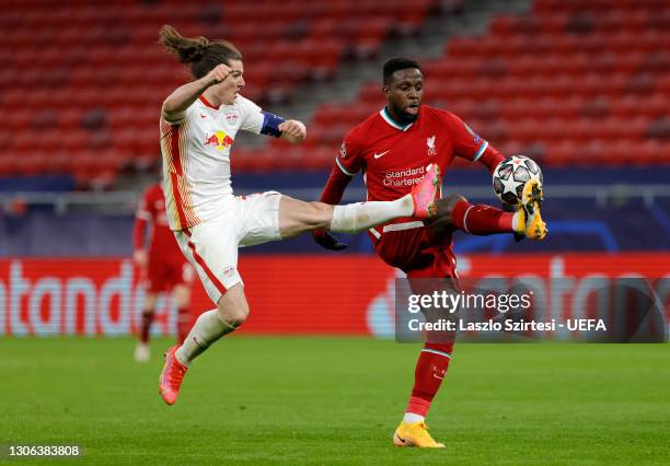 Marcel Sabitzer of RB Leipzig battles for possession with Divock Origi of Liverpool during the UEFA Champions League Round of 16 match between...