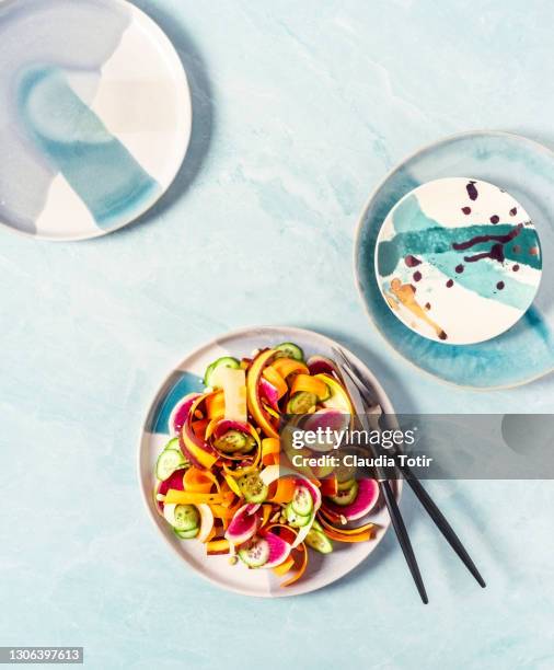 plate of fresh salad on blue background - seasoning ストックフォトと画像