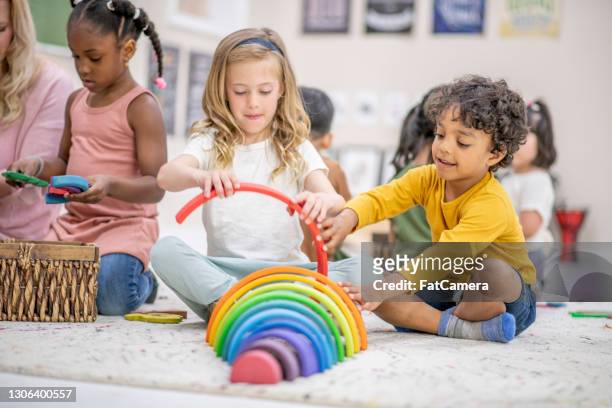 sharing together stock photo - montessori education stock pictures, royalty-free photos & images