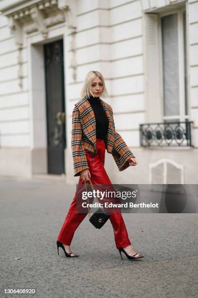 Emy Venturini @sustainably_by_emy wears a black turtleneck pullover from Intimissimi, a brown checked oversized wool coat with large lapels and flare...