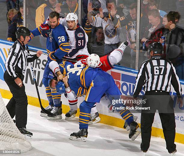 Patrick Kaleta of the Buffalo Sabres takes down Cody Bass of the Columbus Blue Jackets during a fight as Paul Gaustad of the Sabres and Fedor Tyutin...