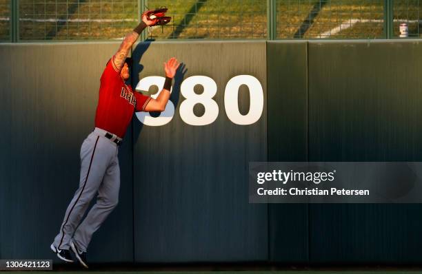 Outfielder David Peralta of the Arizona Diamondbacks makes a leaping catch on a fly ball from Corey Seager of the Los Angeles Dodgers during the...