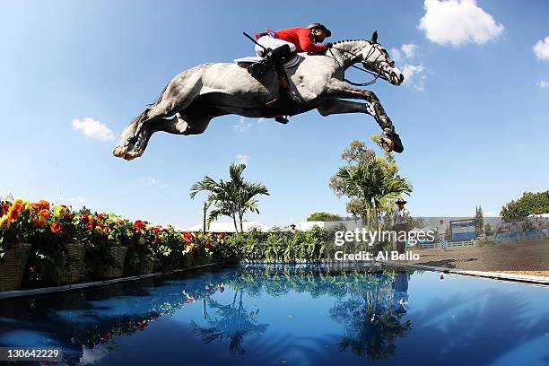 Kent Farrington of the United States makes a jump during the Jumping Competition at the Guadalajara Country Club on Day 13 of the XVI Pan American...