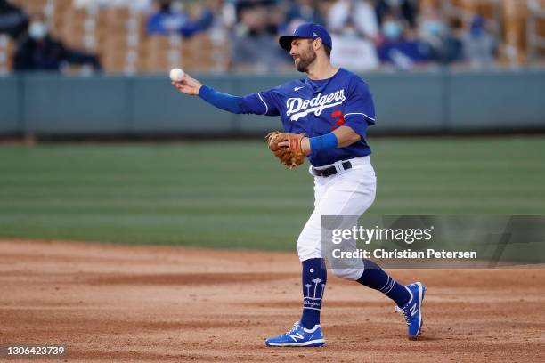 Infielder Chris Taylor of the Los Angeles Dodgers fields a ground ball out against the Arizona Diamondbacks during the second inning of the MLB...