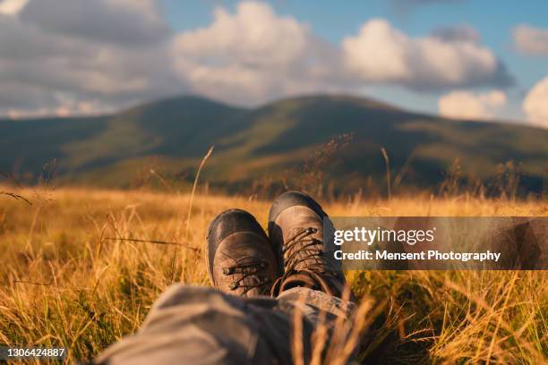 relaxing hikers legs on in mountain adventure european alps - alps romania stock pictures, royalty-free photos & images