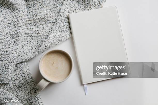 blank white diary with blanket and coffee on white background - stock photo - coffee read stock pictures, royalty-free photos & images