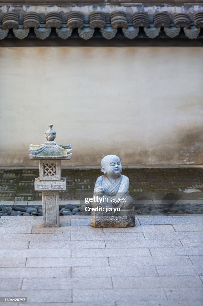 Temple buildings, stone statues of monks and pagodas. Jiangyin City, Jiangsu Province, China.
