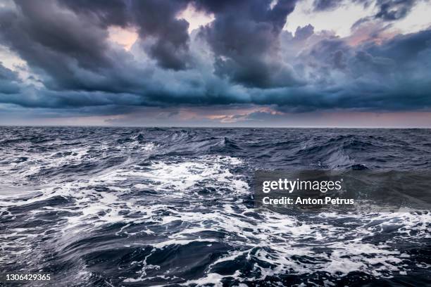 storm on the sea with dramatic clouds at sunset - stormy seascape stock pictures, royalty-free photos & images
